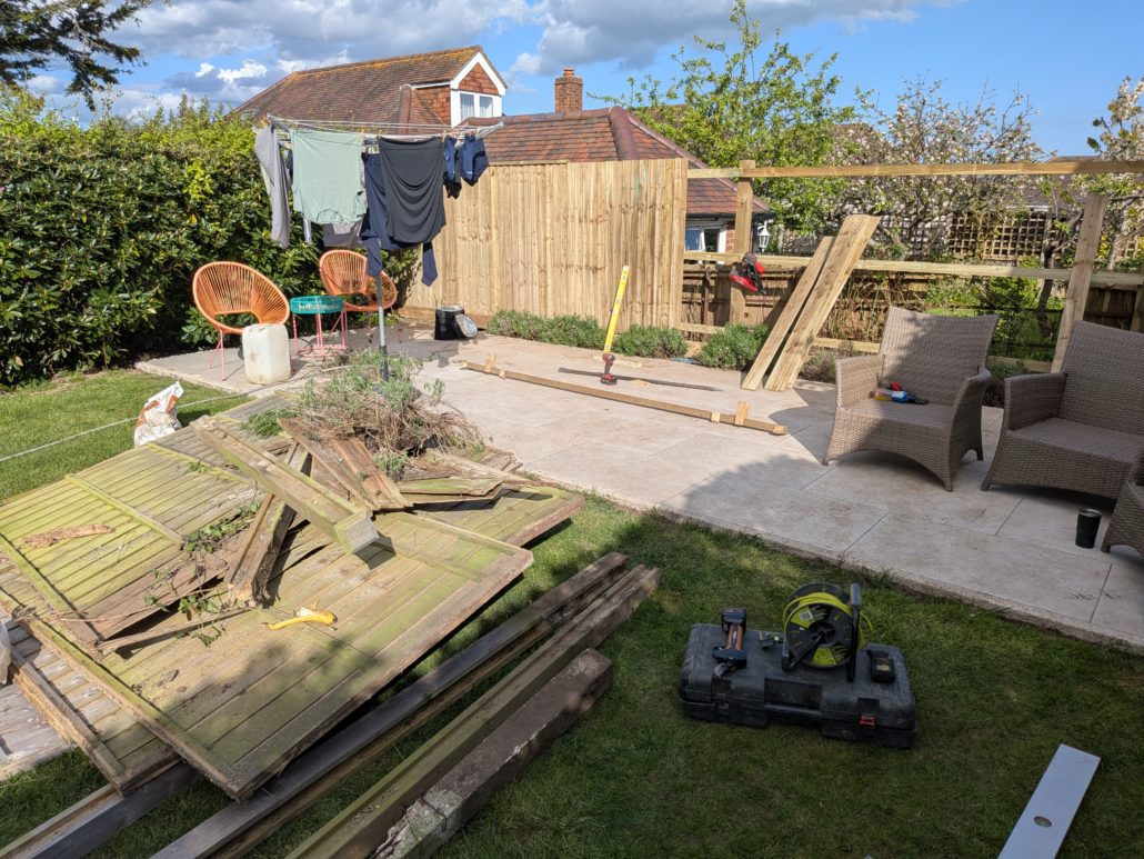 Old damaged garden fence with failed timber posts before replacement in Queens Park