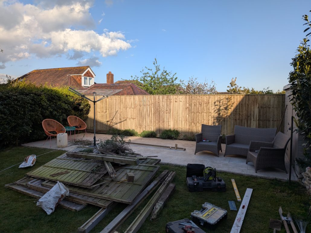 Old damaged garden fence with failed timber posts before replacement in Queens Park