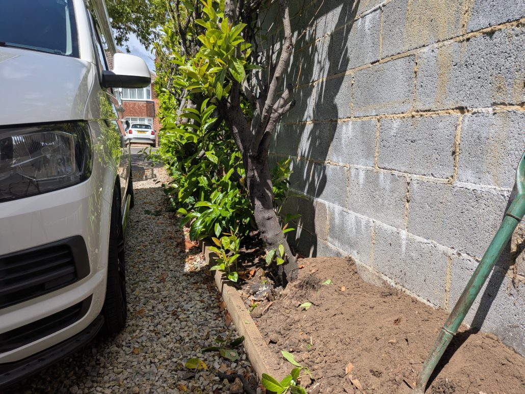 After photo of completed Fencing in Queens Park: Contemporary Slatted Driveway Gates and Parking Widening in Queens Park. - Gallery