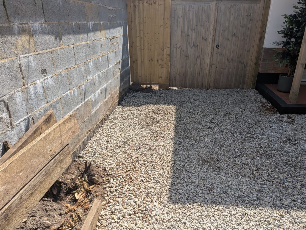 After photo of completed Fencing in Queens Park: Contemporary Slatted Driveway Gates and Parking Widening in Queens Park. - Gallery