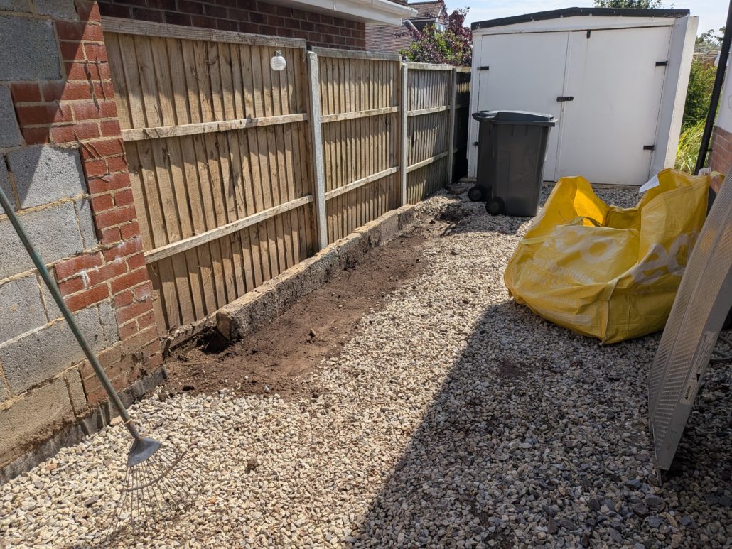 After photo of completed Fencing in Queens Park: Contemporary Slatted Driveway Gates and Parking Widening in Queens Park. - Gallery