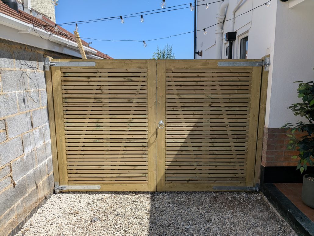 After photo of completed Fencing in Queens Park: Contemporary Slatted Driveway Gates and Parking Widening in Queens Park. - Gallery