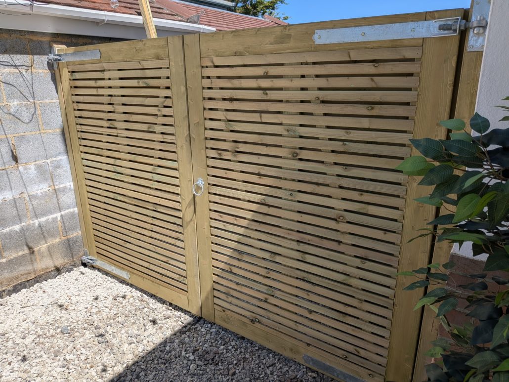 After photo of completed Fencing in Queens Park: Contemporary Slatted Driveway Gates and Parking Widening in Queens Park. - Gallery